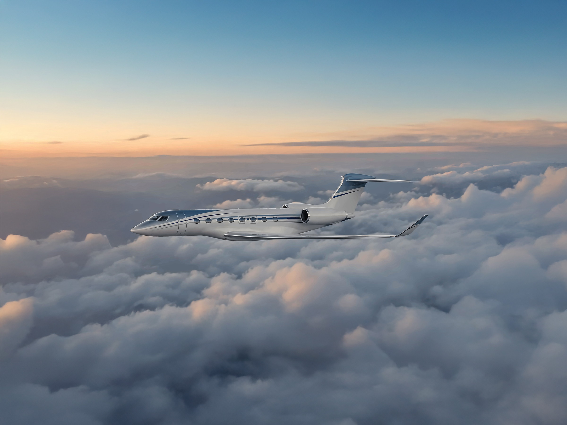 The Gulfstream G650ER in flight above the clouds at sunset.