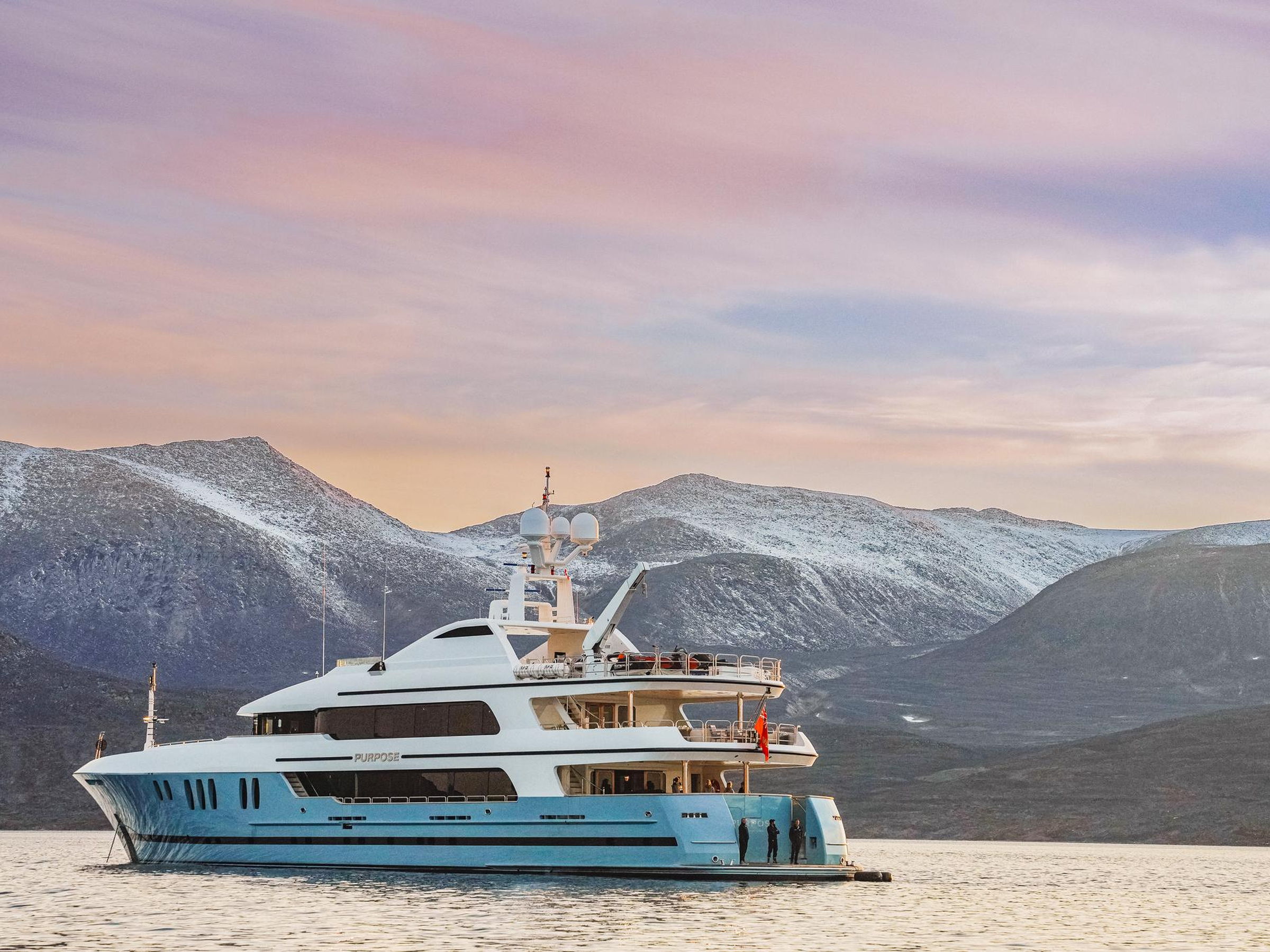 M/Y Purpose at anchor beneath snow-dusted mountains.