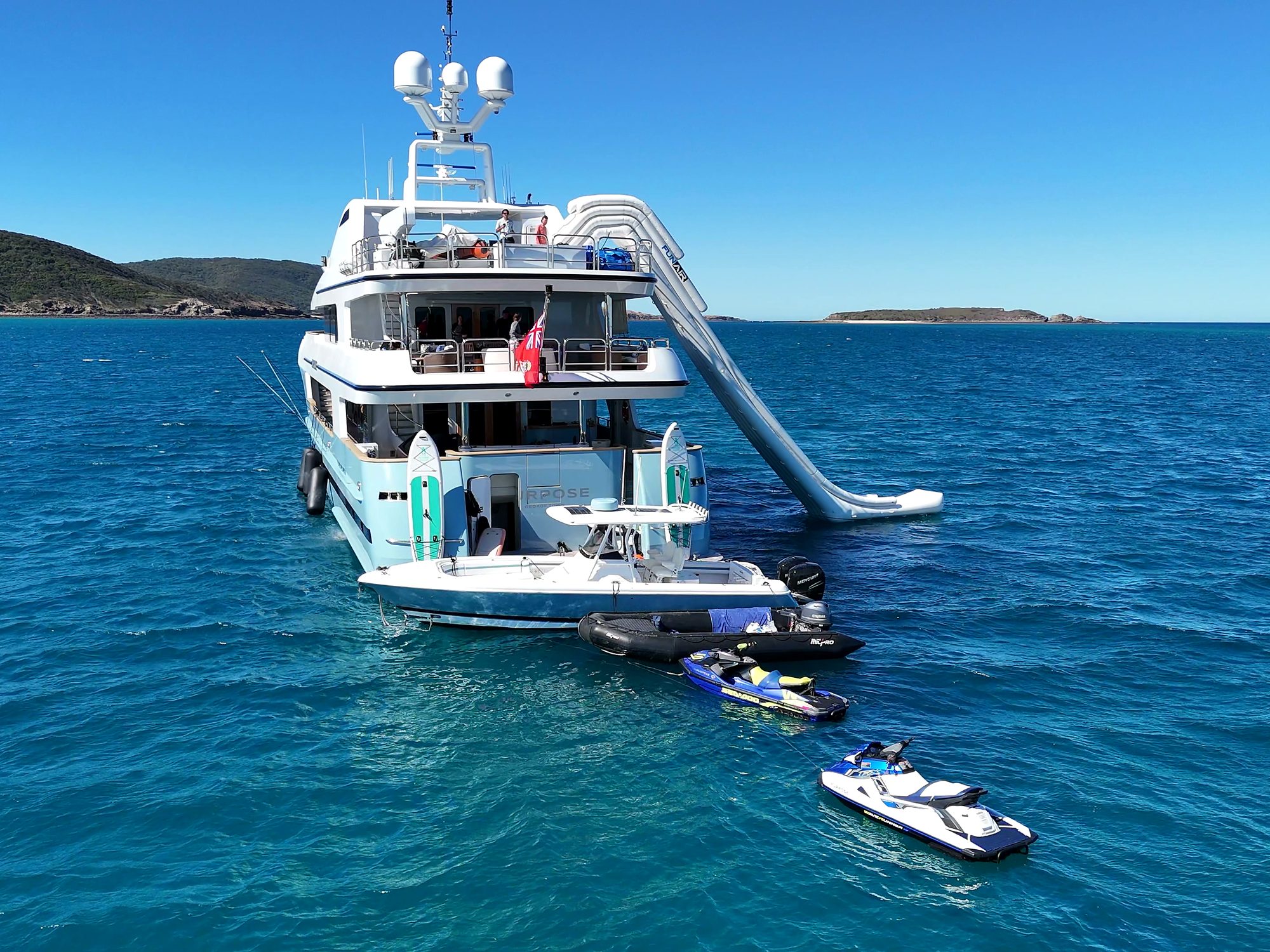 Jet skis moored alongside, slide deployed.